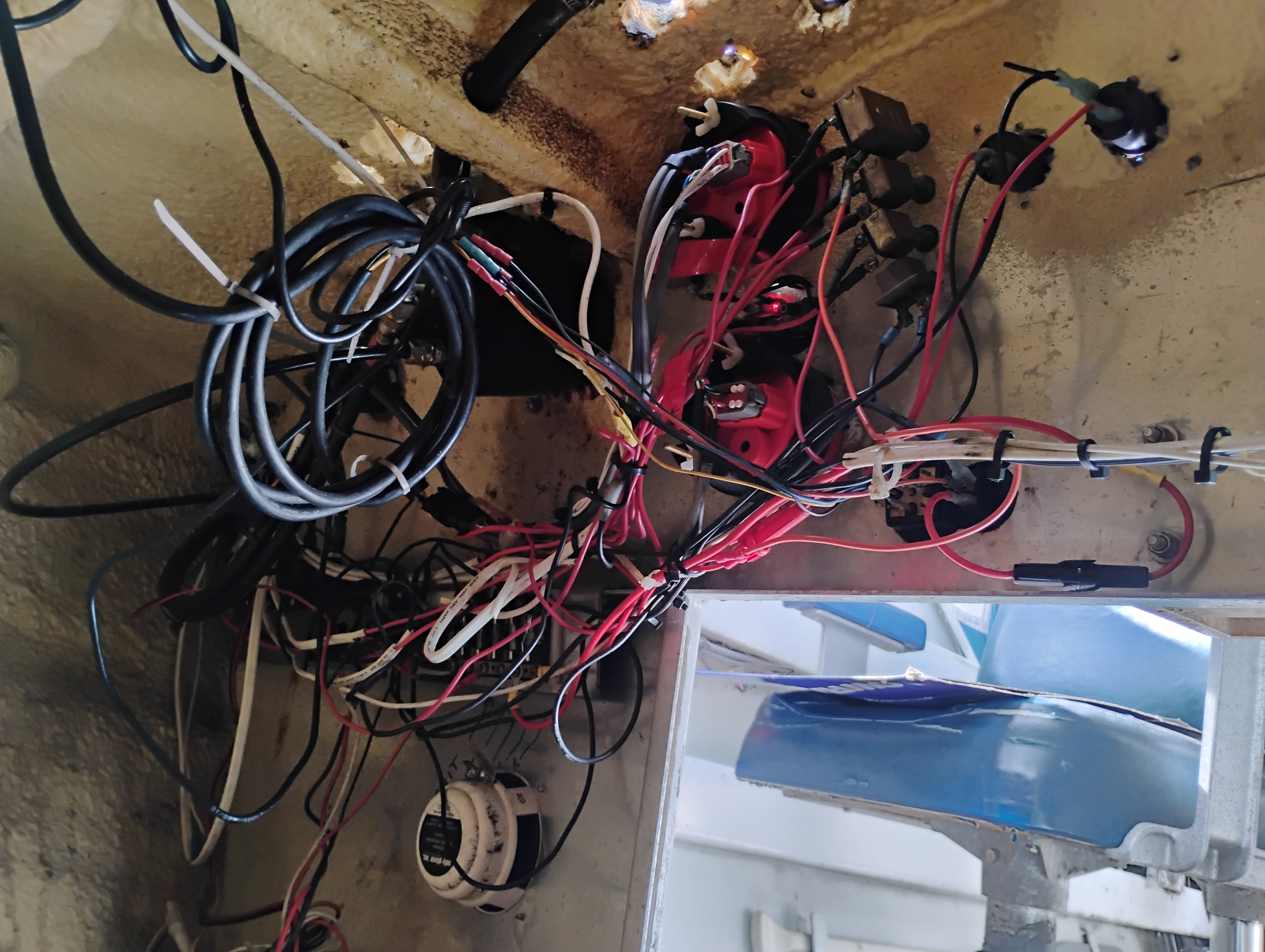 Pre-removal marine wiring harness laid out for documentation before re-routing