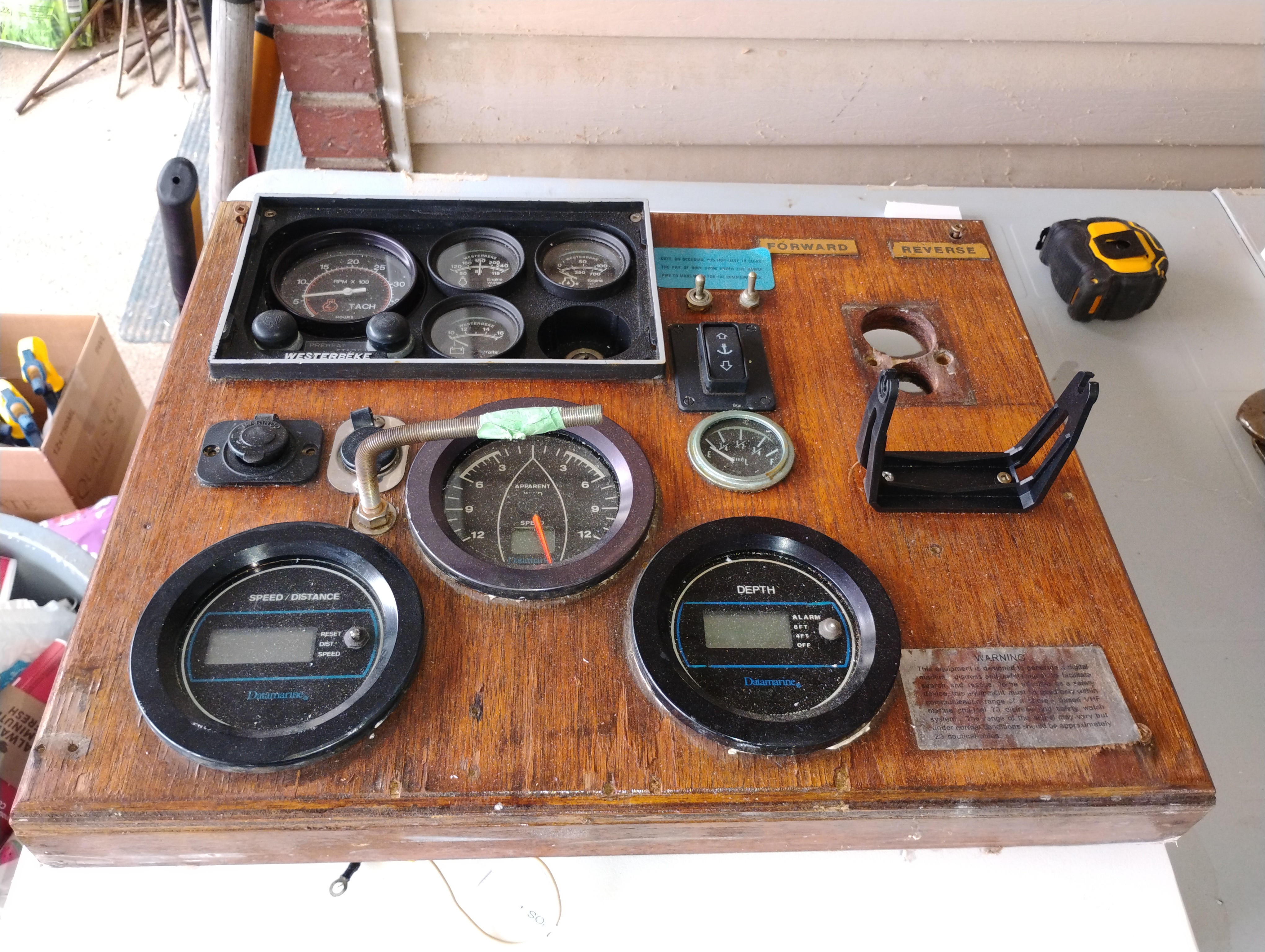 Marine helm dash with multiple instrument cutouts during a chartplotter installation