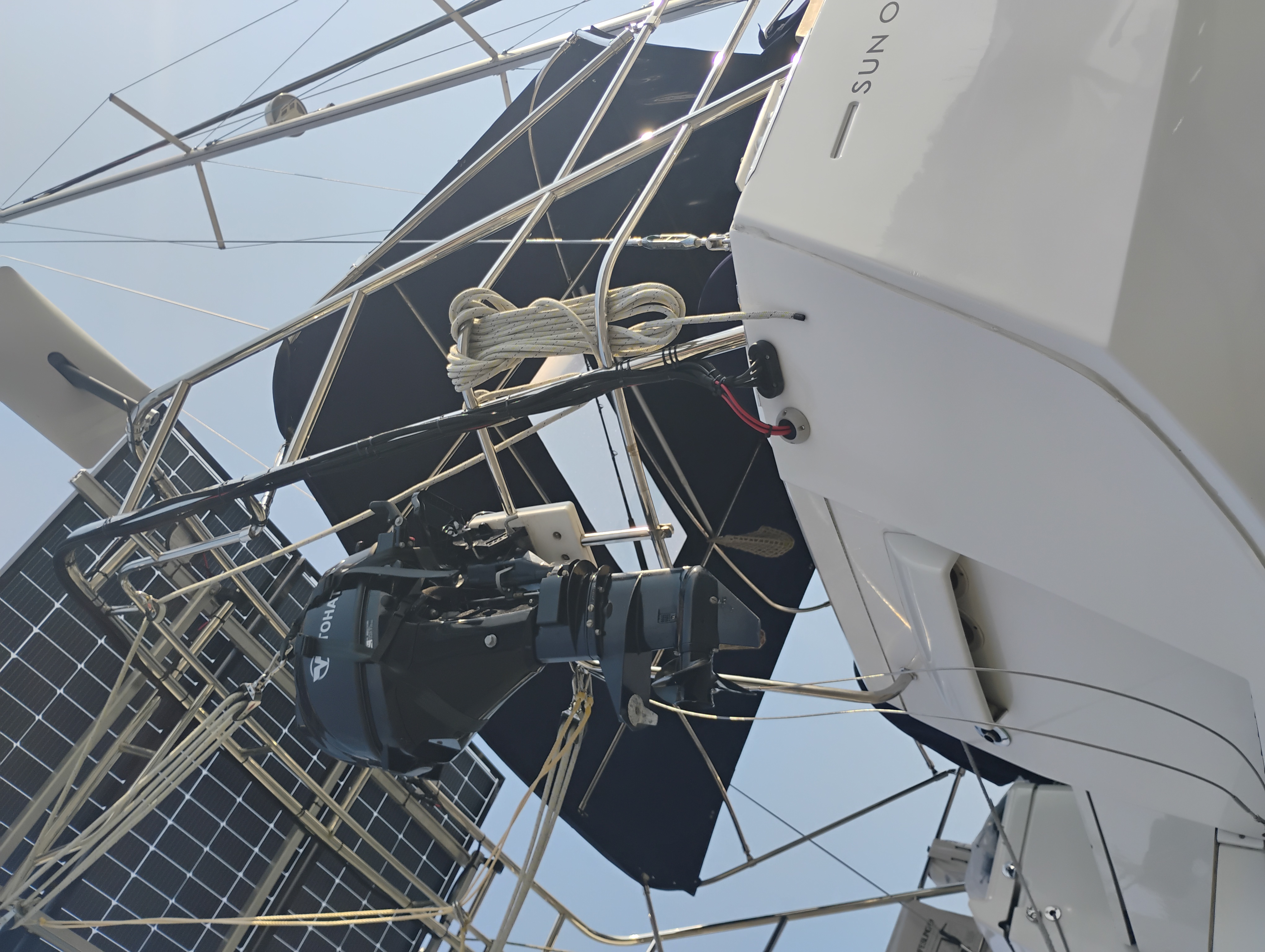 Sailboat stern arch with multiple distributed solar panels installed across the frame
