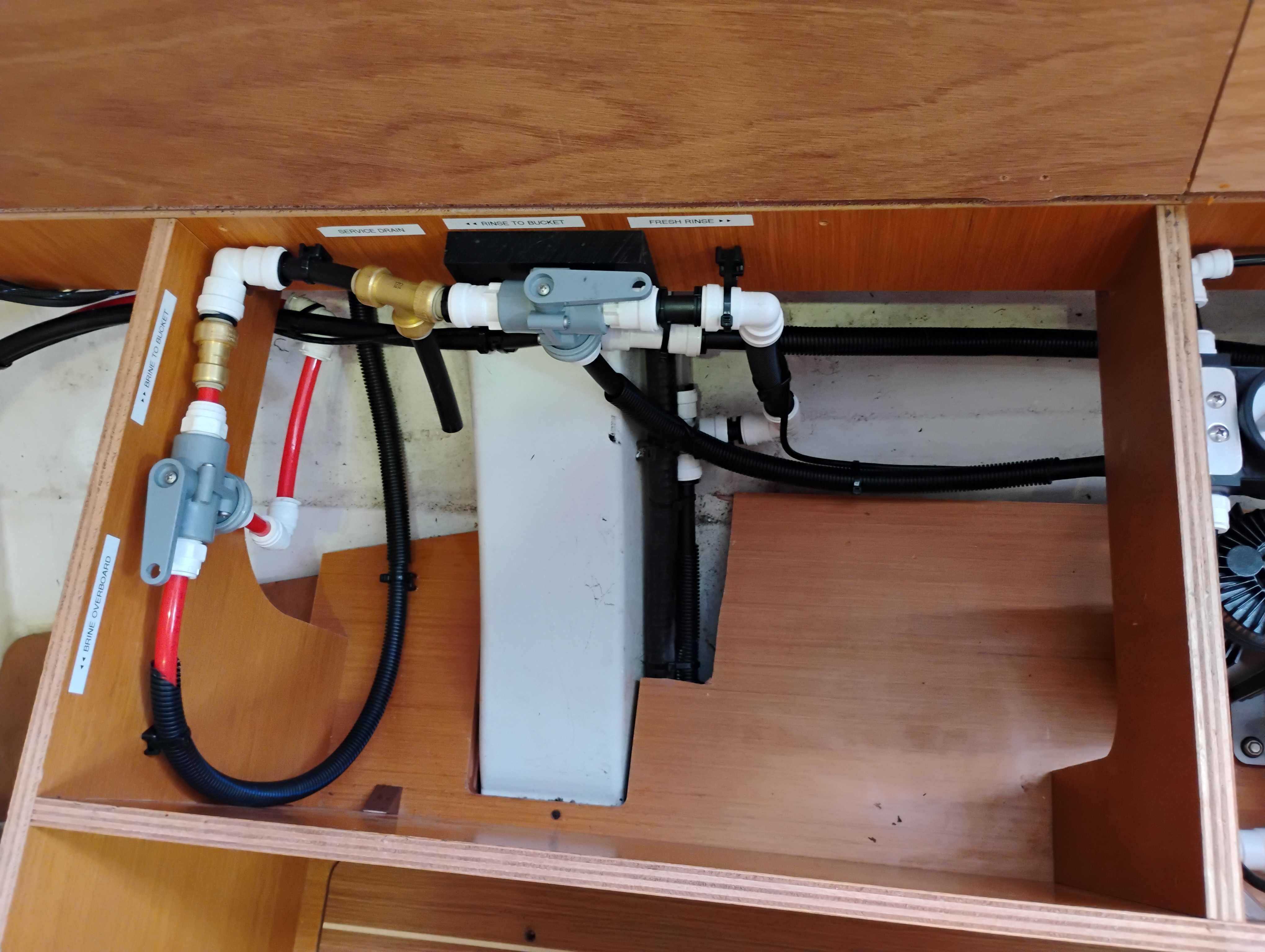 Watermaker pressure controls and plumbing valves installed in a vessel mechanical bay